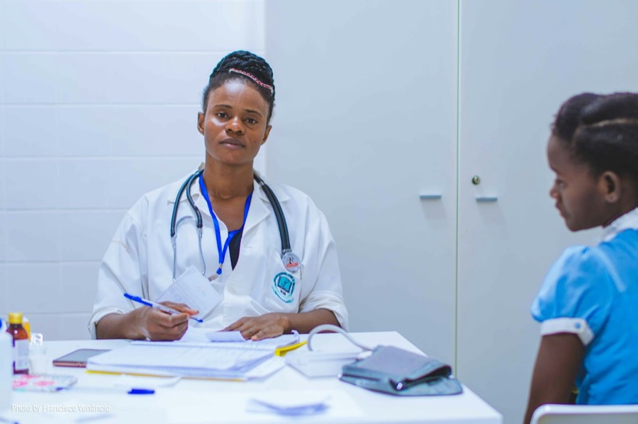 Health worker attending to a young patient